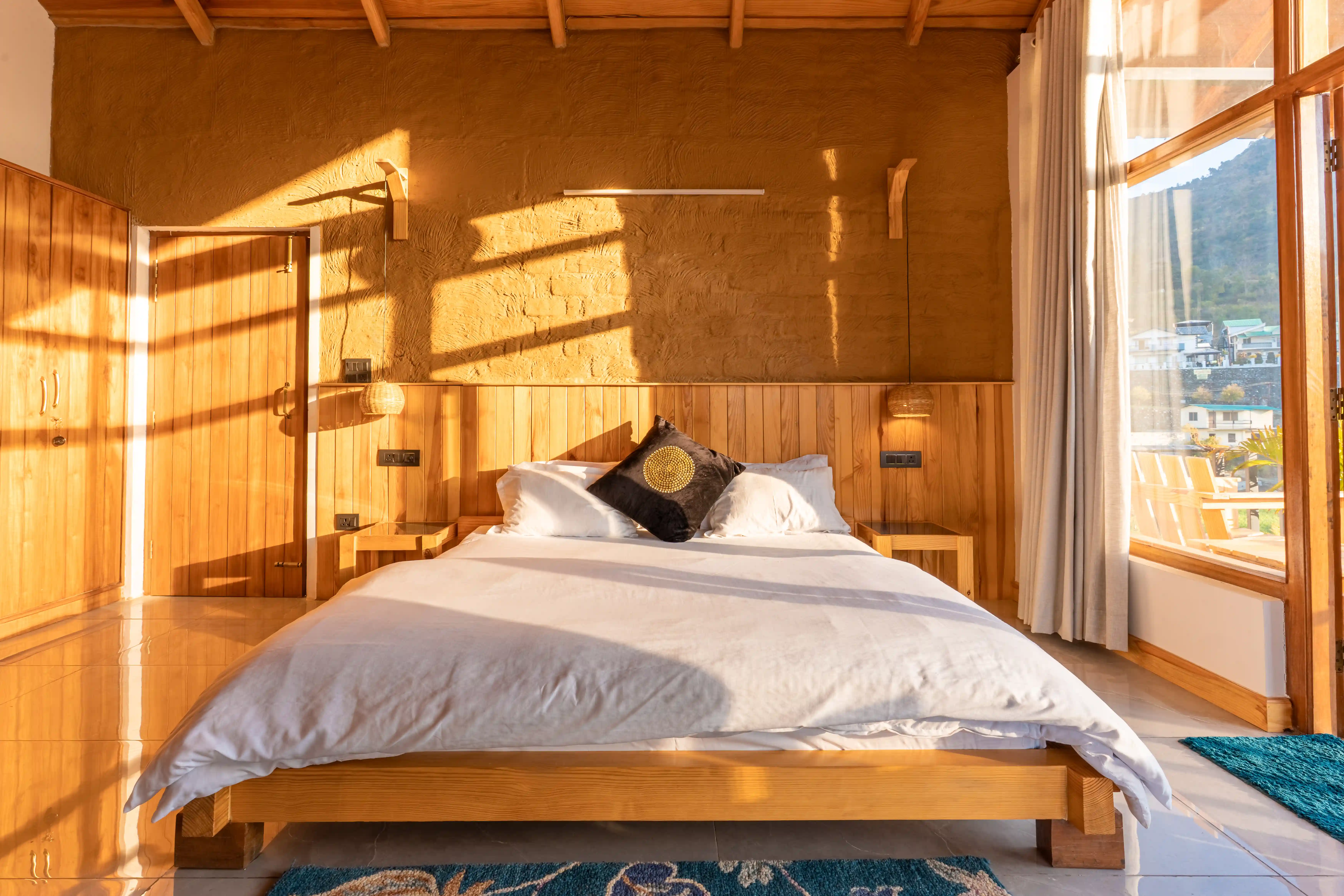 Handcrafted wooden bedroom detail with organic cotton quilts