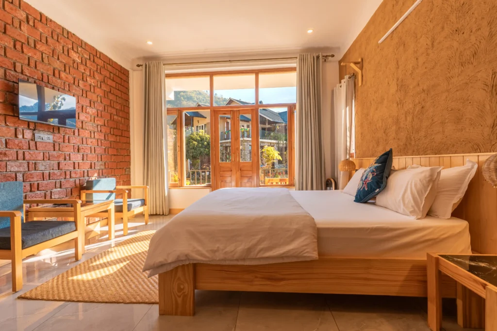 Wooden balcony view of Naukuchiatal from The Darma Retreat at Ethnic Trail Homestay.