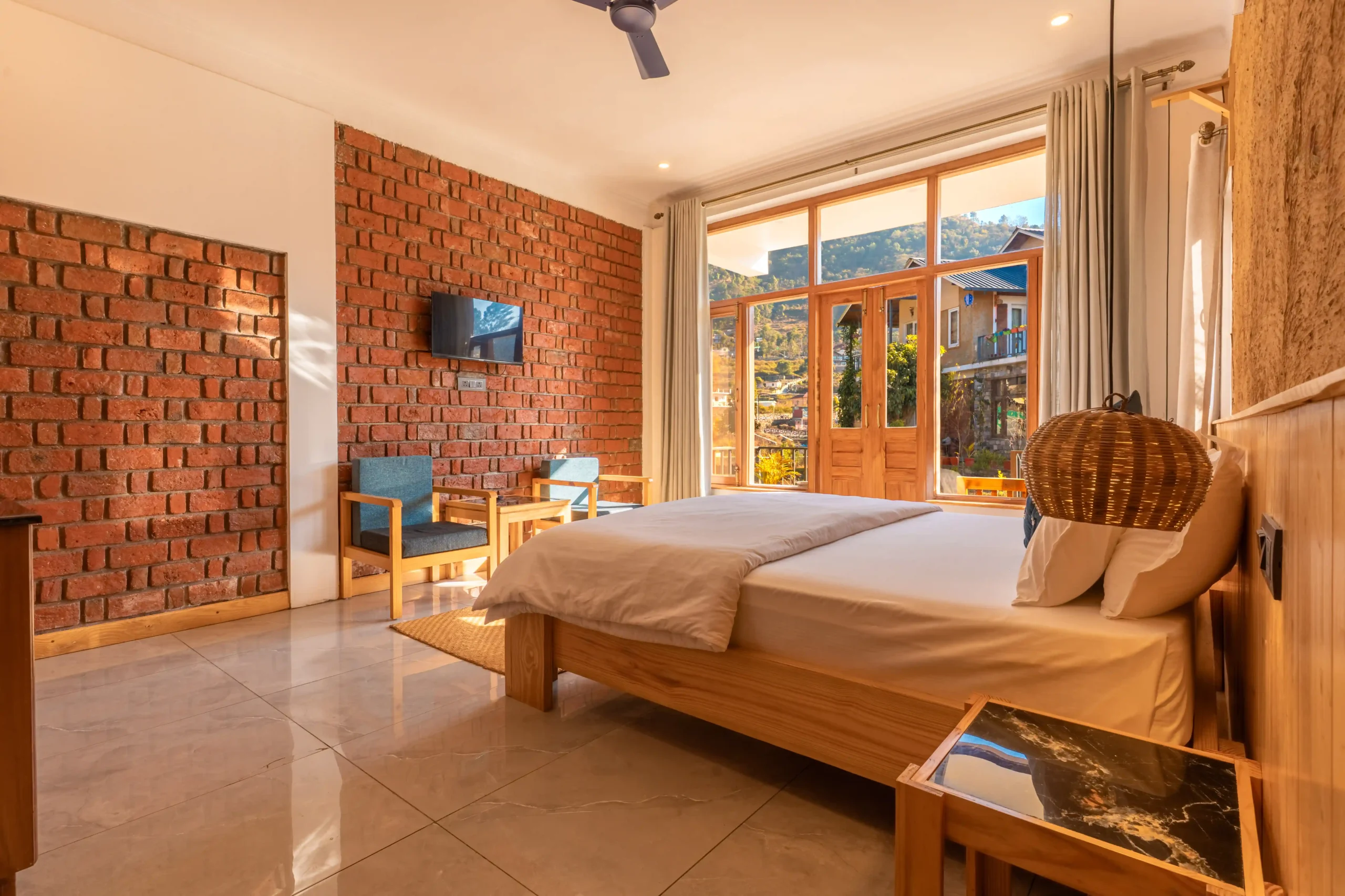 Sunlit bedroom with traditional Dharchula architecture in The Rung Retreat Naukuchiatal.