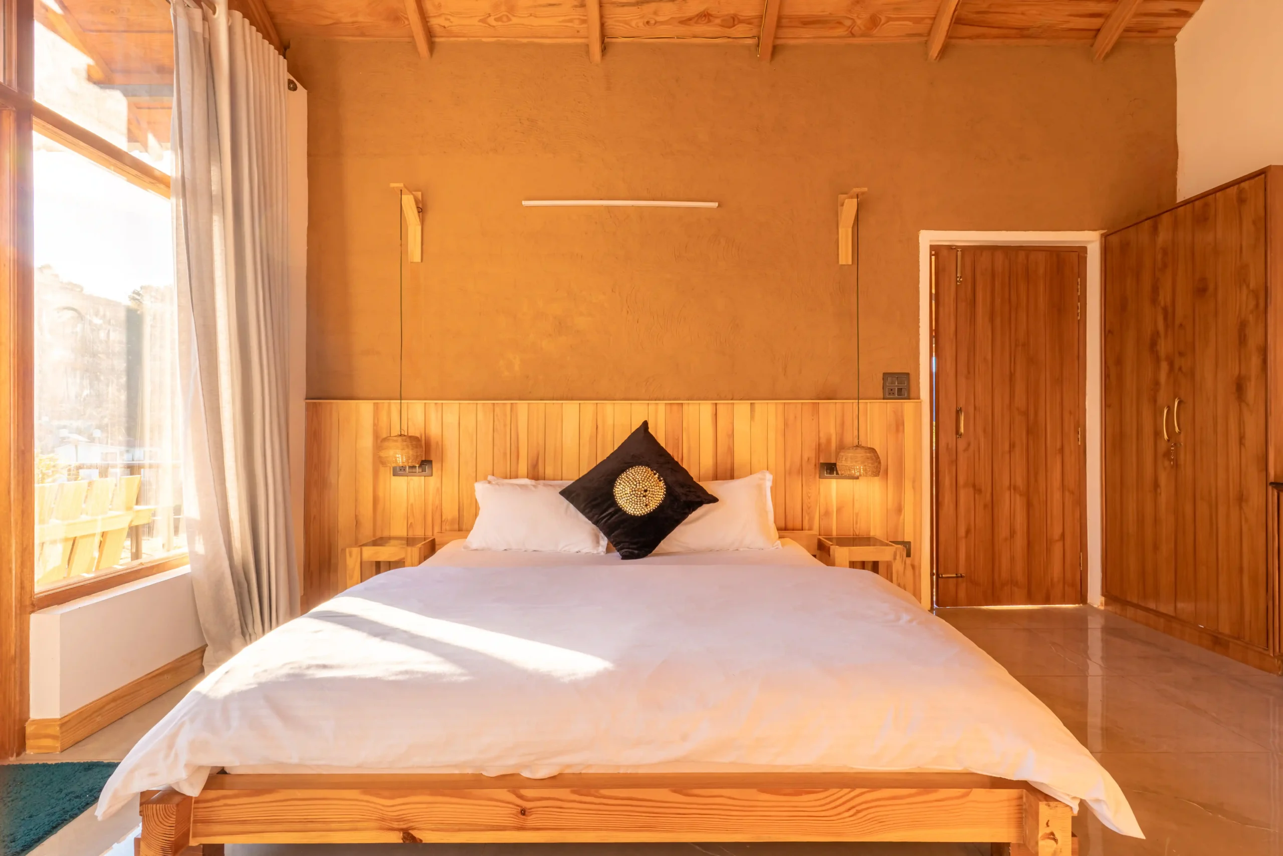 spacious Heritage Deluxe Room with traditional wooden interiors at Ethnic Trail Homestay Naukuchiatal.
